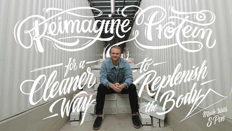The Co-Founder and CEO of Après, Sonny McCraken sits on a pile of boxes containing his product. There is handwritten script overlayed on top of the photo that reads: "Reimagine protein for a cleaner way to replenish the body. Made with S Pen".