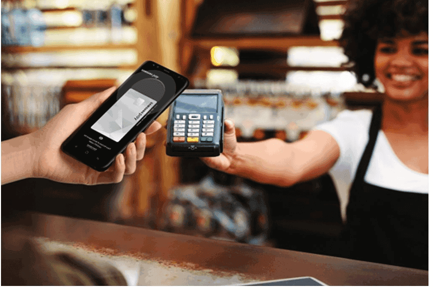 Cashier Pointing Card Machine Towards Samsung Pay App