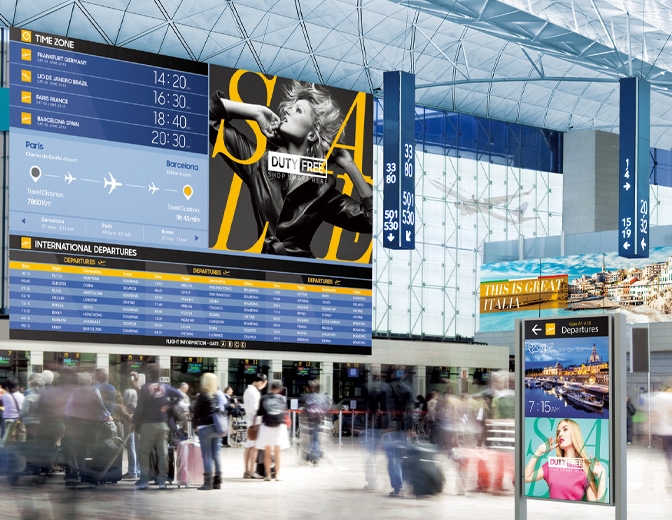 공항 내 벽면 거대한 전광판에 광고, 지역별 날씨, 비행기 시간 등이 함께 출력되는 이미지.