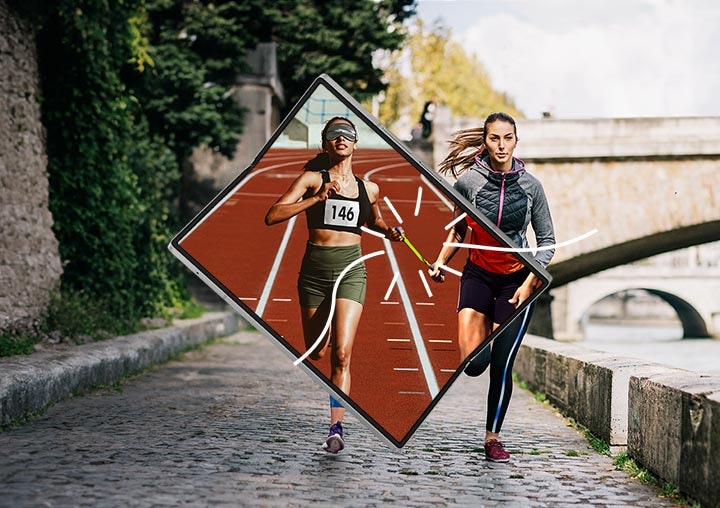 배경에 돌다리가 있는 강 좌측으로 자갈길이 있습니다. 중앙에는 Galaxy Z Fold6의 화면이 펼쳐져 있고, 두 여성이 자갈길에서 달리는 모습이 화면과 배경에서 겹쳐 보여지고 있습니다. 화면 속에서 두 여성은 유니폼을 입고 패럴림픽 육상 경기에서 경쟁하고 있습니다. 오른쪽 상단에 올림픽 링, 삼성 로고, 아지토스 로고가 표시되어 있습니다. 아래에는 "WORLDWIDE OLYMPIC AND PARALYMPIC PARTNER"라는 문구가 적혀 있습니다.