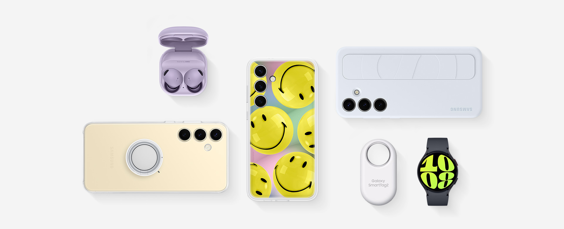 A flat lay of accessories for Samsung Galaxy S24 Plus: Galaxy Buds2 Pro in Bora Purple with the cradle open and the ear buds in place, Galaxy S24 Plus with the Clear Gadget Case installed, Galaxy S24 Plus with Flipsuit Case in Yellow installed, Galaxy S24 Plus with the Standing Grip Case in Light Blue installed, Galaxy SmartTag2 in White and Galaxy Watch6 in Graphite.