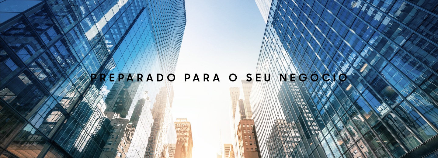 A skyward facing photo between multiple glass skyscrapers with text overlaid that says Ready for business