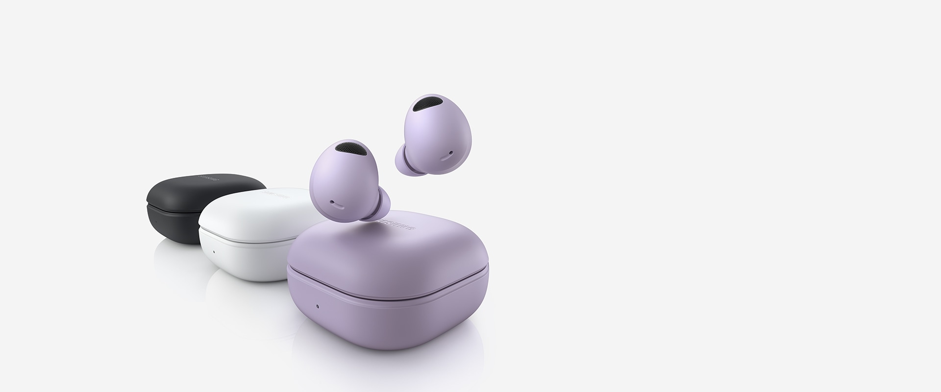 Three Galaxy Buds2 Pro devices are lined up. The Bora Purple Galaxy Buds2 Pro device in the front has two earbuds hovering above the closed case. The middle White closed case is followed by a closed Graphite Galaxy Buds2 Pro case.