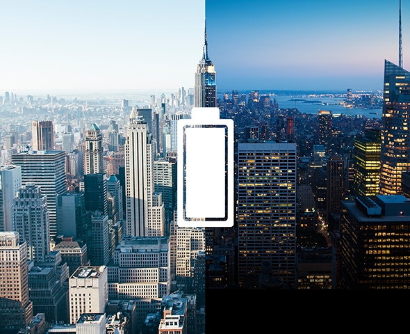 City skyline split vertically between day and night with a battery icon in the center.