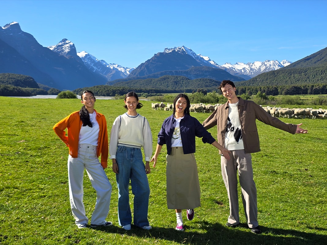 A photo of an open field and mountains with a group of friends in the foreground at 2x optical quality zoom.