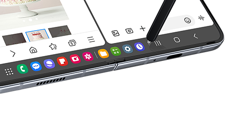 The Task Bar Is Featured At The Bottom Of The Main Screen. An S Pen Hovers Over One Of The Many App Icons Pinned To The Task Bar.