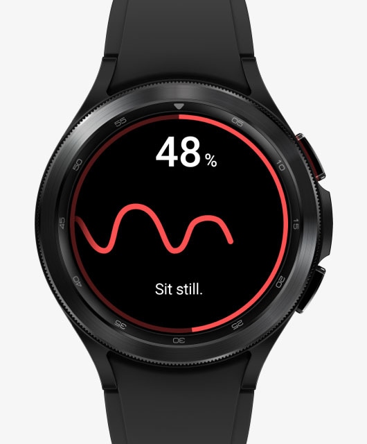 The front watch face of the Galaxy Watch4 Classic device is measuring blood pressure. Its display changes from the blood pressure measuring feature to the ECG measuring feature.
