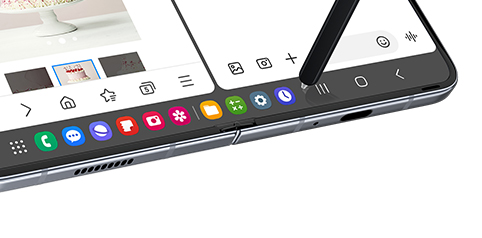 La barra de tareas aparece en la parte inferior de la pantalla principal. Un S Pen se desplaza sobre uno de los muchos iconos de aplicaciones fijados a la barra de tareas.