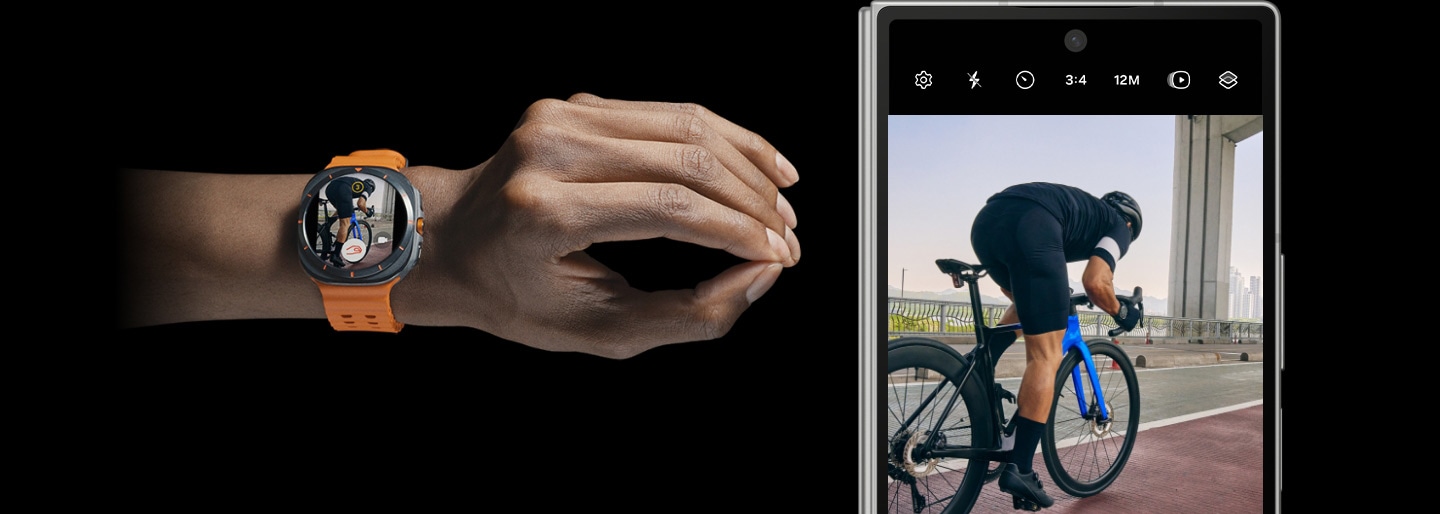 Una mano que lleva un Galaxy Watch Ultra hace un movimiento de doble pellizco. A su lado está el Galaxy Z Fold6 emparejado con su Cover screen que muestra la pantalla de una cámara que graba a un hombre en bicicleta.