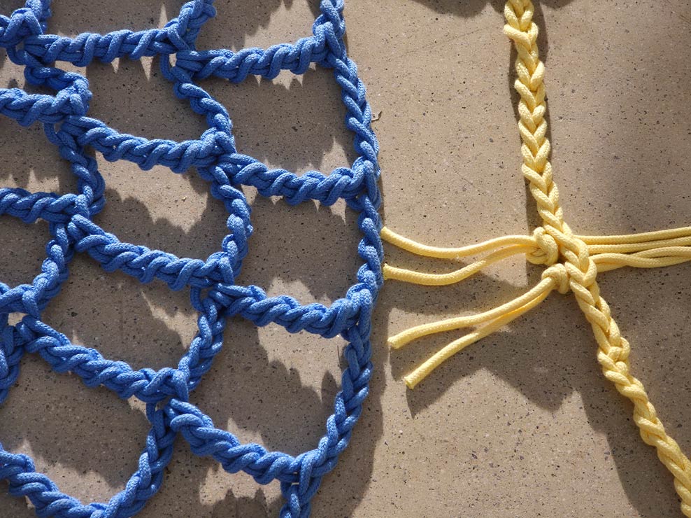 Telephoto shot of details of coloured rope in a museum. Colours are vivid.