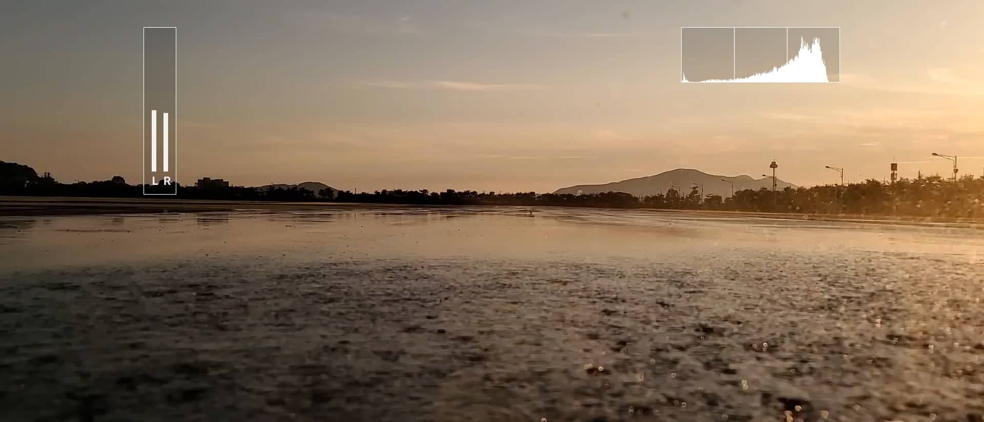 120fps scene shot on Galaxy Note20 Ultra of cars driving on a road covered in water. It's shown with the Pro Video interface to demonstrate the various features you can adjust when recording for a more professional video. Audio option, ISO option, shutter speed option, aperture option, auto focus, and white balance option.