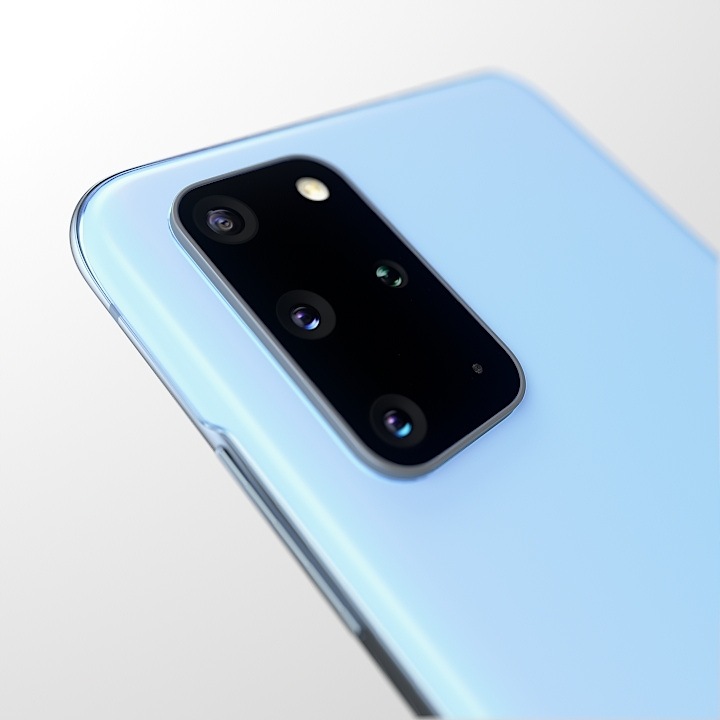 A blue Samsung Galaxy S20 plus is laid on its back and tilted slightly to the left, showing 30x zoom camera with 64 megapixel