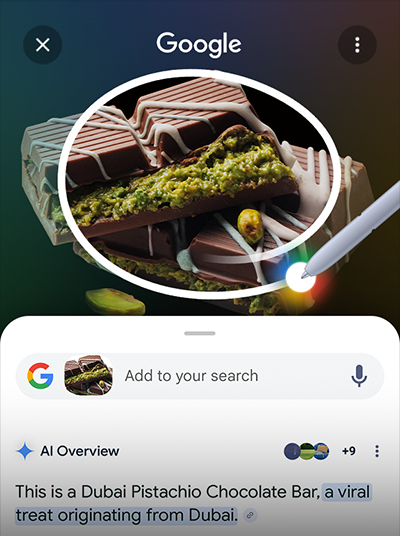 S Pen circles around some Dubai chocolate. Google search bar is seen underneath with AI Overview results.