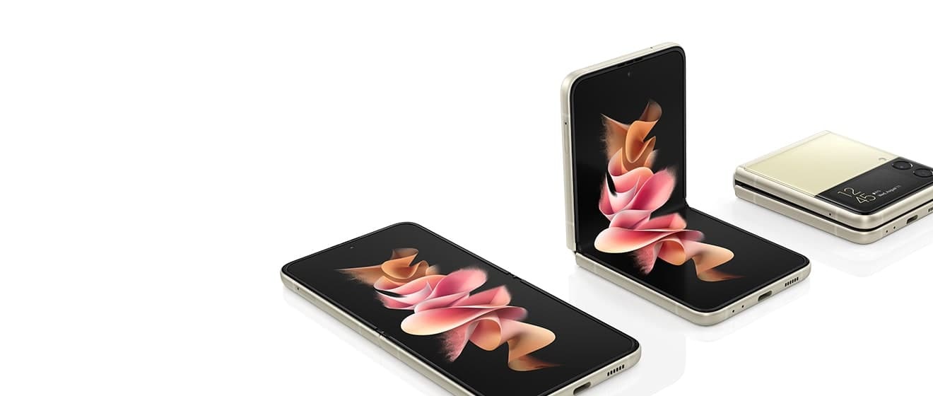 Three Galaxy Z Flip3 5G phones. One is unfolded and laying with a colorful wallpaper on the Main Screen. One is in Flex mode with a colorful wallpaper on the Main Screen. One is folded with the time displayed on the Cover Screen.