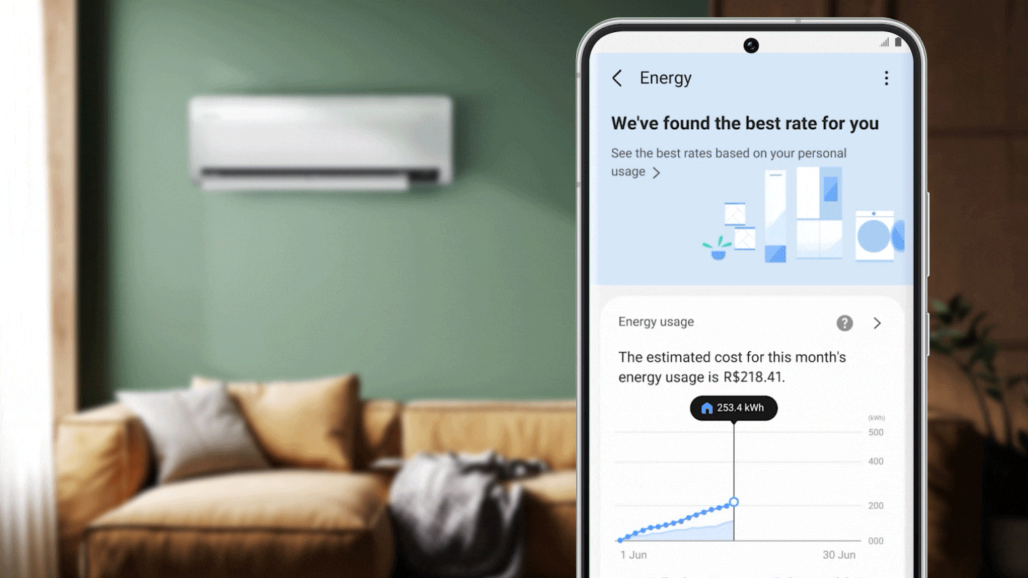 Hình ảnh hiển thị một máy điều hòa gắn tường trong phòng khách. Ứng dụng SmartThings Energy cũng được hiển thị trên điện thoại thông minh. Ứng dụng này bao gồm tùy chọn tìm kiếm mức giá cung cấp năng lượng tốt nhất dựa trên mức sử dụng năng lượng cá nhân của bạn. Nó cũng hiển thị biểu đồ ước tính mức sử dụng năng lượng và chi phí trong tháng. Bên dưới đó là sơ đồ tổng năng lượng đã sử dụng và tỷ lệ phần trăm tiết kiệm được.