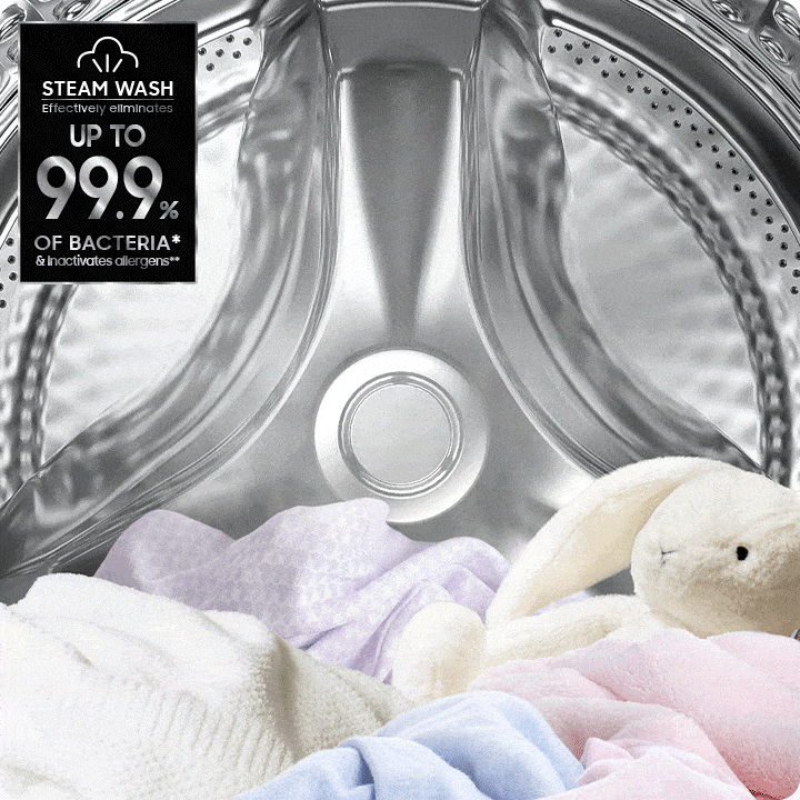 Several articles of clothing and a stuffed animal are inside a Samsung Bespoke Grande AI washer. It fills with steam. On the top left corner is a label with the text Steam wash effectively eliminates 99.9% of bacterial and inactivates allergens.