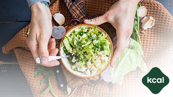 A women is seen holding a bowl of healthy salad