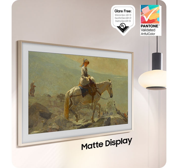 The Frame, which is turned off, reflects the light of a lamp hanging from the ceiling right next to it. The words Non Matte Display show below The Frame. Glare Free: Reflection Glare UGR<10, Discomfort Glare UGR<22, Disability Glare UGR<34, UL logo. PANTONE Validated ArtfulColor logo.