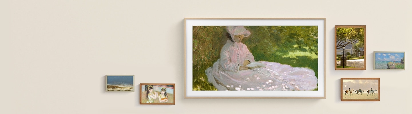 The Frame TV displays a large artwork surrounded by smaller framed pieces, highlighting how it elevates a space like real wall art.