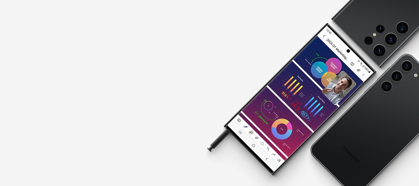 Un plano de tres teléfonos inteligentes: dos dispositivos Galaxy S23 Ultra y un Galaxy S23 plus. Uno de los Galaxy Ultra se ve de frente con un S Pen parcialmente insertado en la parte inferior del smartphone. La pantalla muestra tres diapositivas de una presentación abierta en una aplicación con una ventana flotante de un videochat en la parte superior. Los otros Galaxy S23 Ultra y Galaxy S23 plus son en Phantom Black y se ven desde detrás.
