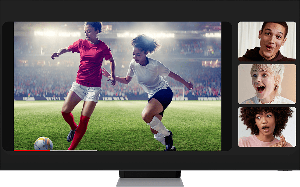 Two women playing soccer zooms out to become a video that three people are watching during a video call using Google Duo. The call is being cast onto a TV. Galaxy S22 plus moves in front of the TV from offscreen to show the same video call on the screen.