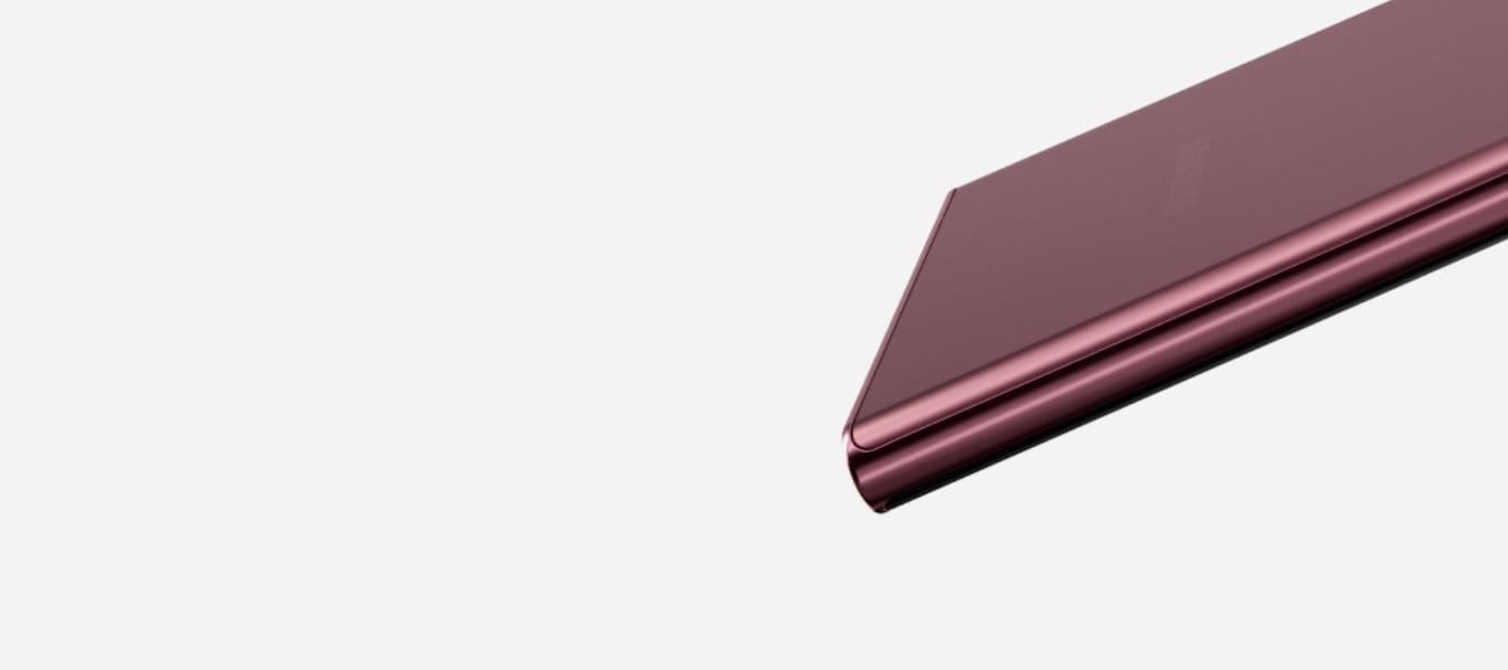 A close up on the S Pen cradle on Galaxy S22 Ultra in Burgundy. As the phone moves down and turns to focus on the rear cameras, S Pen moves out of the cradle and sits next to the phone.