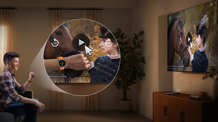 A man uses his Galaxy Watch to control a TV across the room, hitting play for a scene of a woman petting a horse.