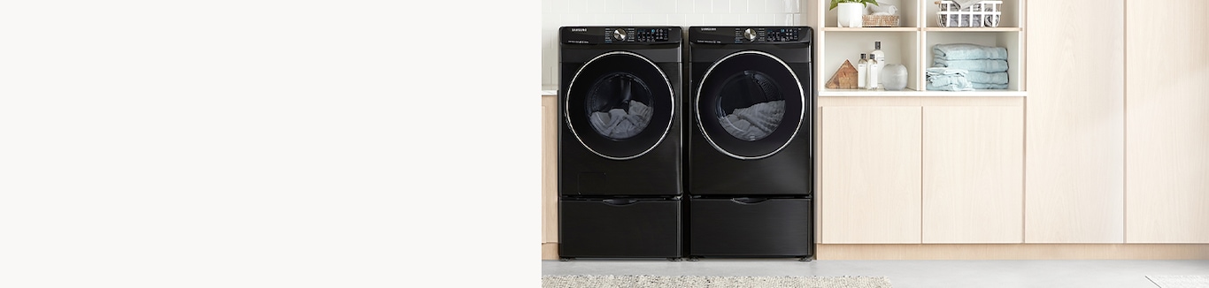 A modern laundry room with new 5.2 cu. ft. Smart Front Load Washer with Super Speed and matching dyer in Black Stainless Steel shown facing forward.