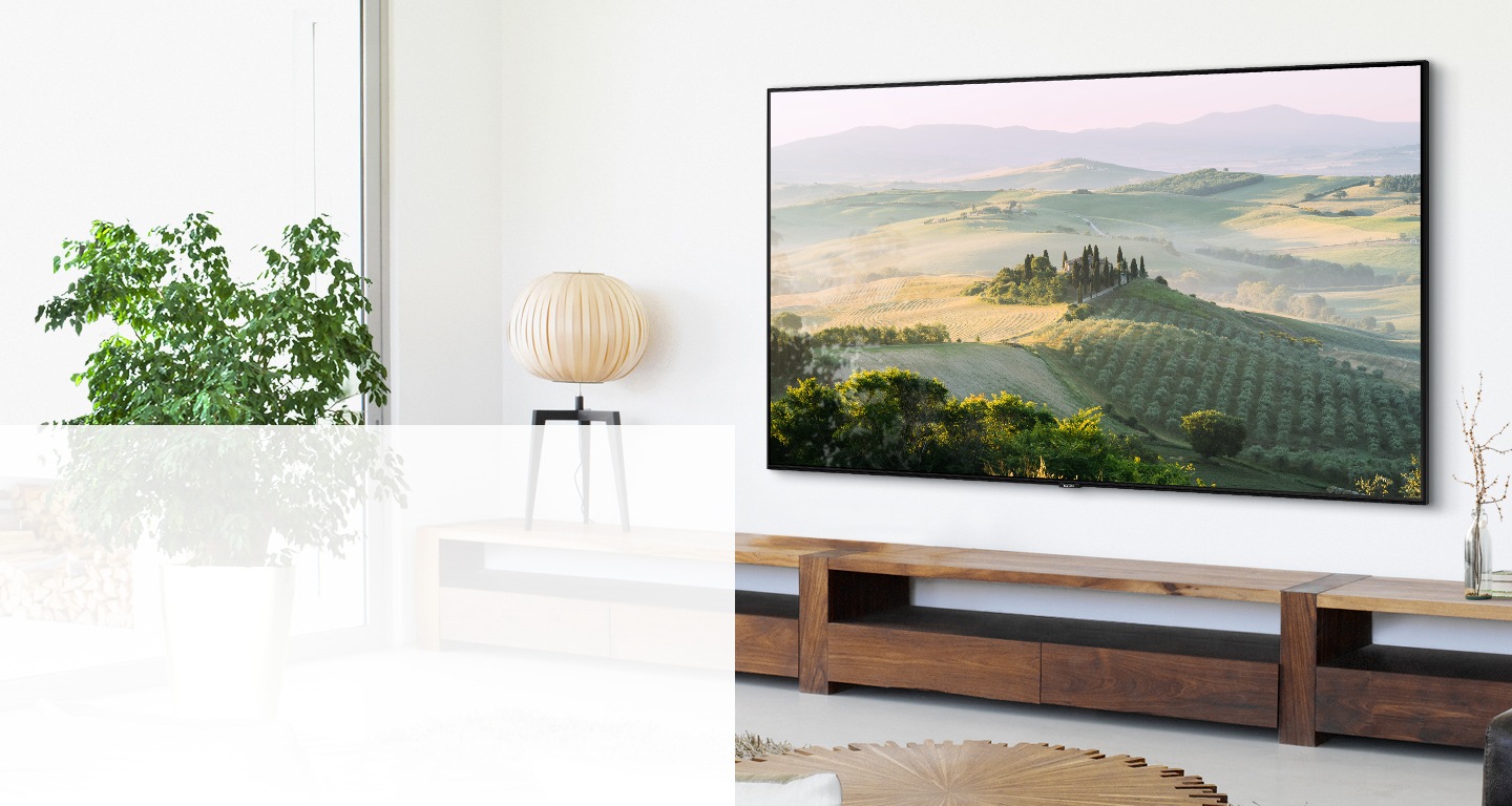 A Samsung TV mounted to a wall in a living room