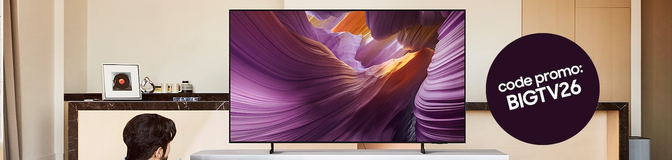 On voit un téléviseur OLED posé sur un buffet dans un salon. À droite, un cercle noir avec l'inscription « Code promo : BIGTV26 » est représenté.