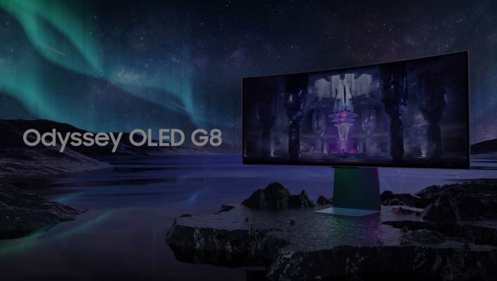 The Odyssey OLED G8 sits on a desk, with futuristic ruins on screen.