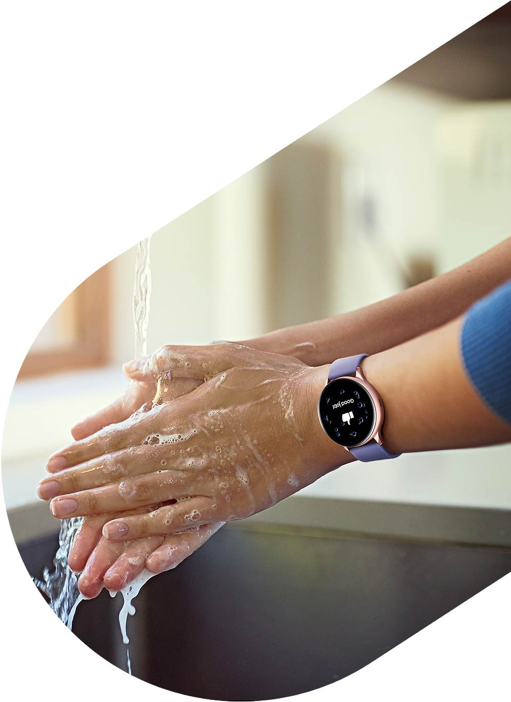 A person washes their hands while wearing the Rose Gold Galaxy Watch Active2.