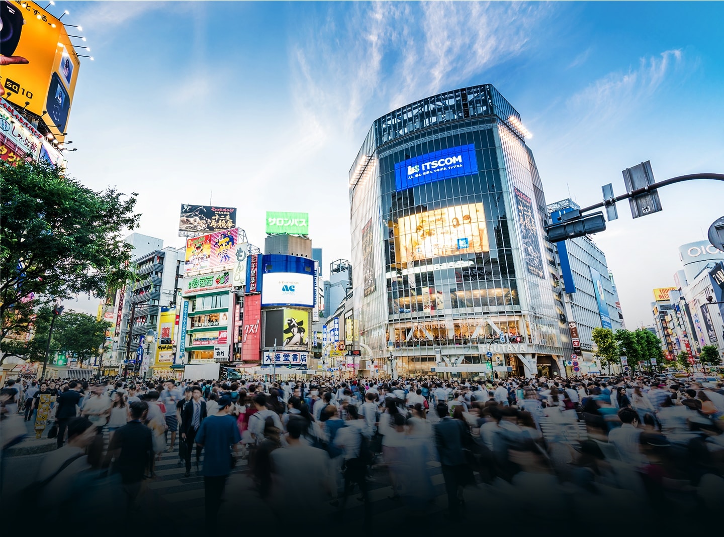 A photo image of downtown Japan where many people pass by.