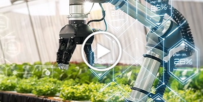 Video - An image of a robotic hand and plants growing indoors behind it.