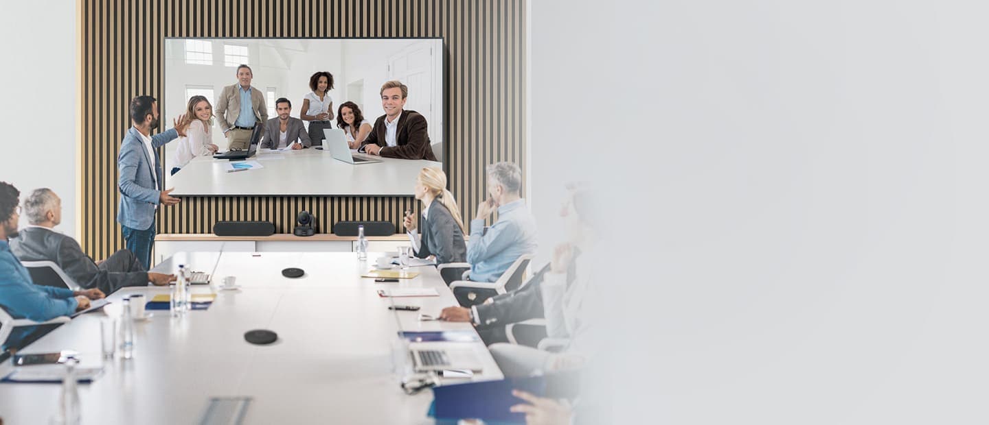 More than ten people are meeting using the Samsung and Logitech video conferencing solution in large meeting room.
