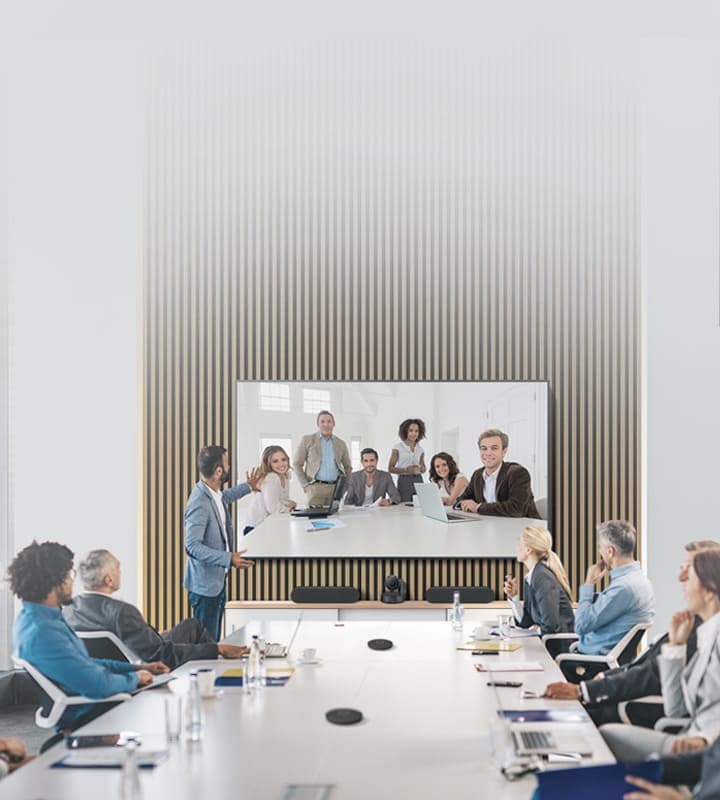 More than ten people are meeting using the Samsung and Logitech video conferencing solution in large meeting room.