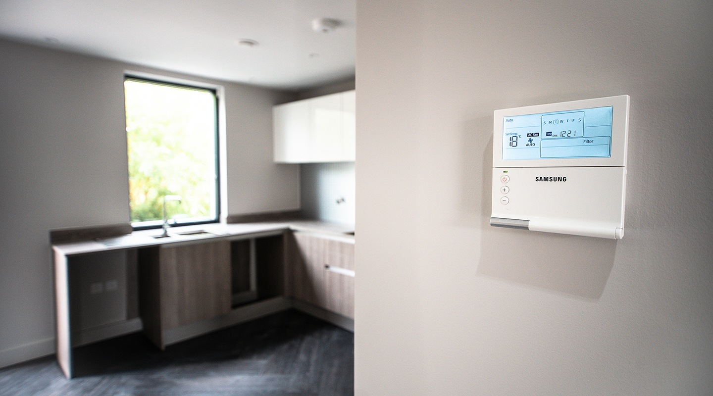 An Air Conditioning Control panel on the wall inside one of the Etopia houses