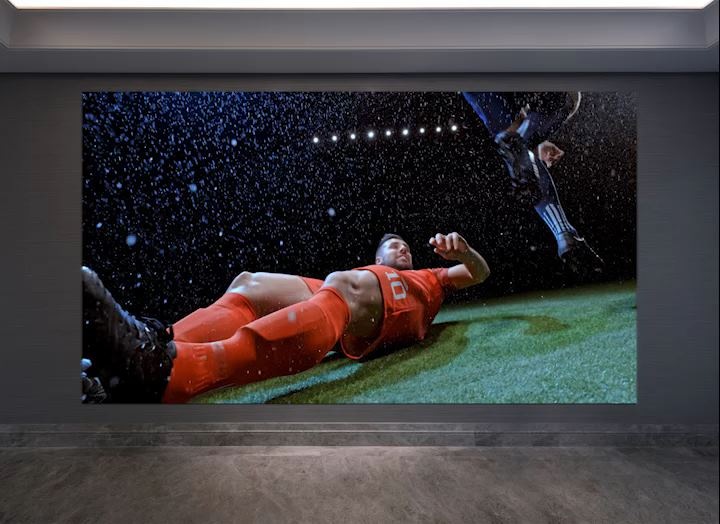 The soccer game screen sharpens and shrinks at the same time, revealing the wall with The Wall installed.