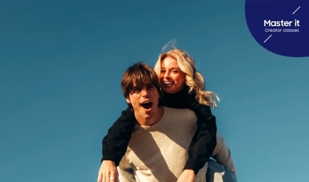 A couple portrait of a man with a woman on his back laughing. Master it. Creator classes.