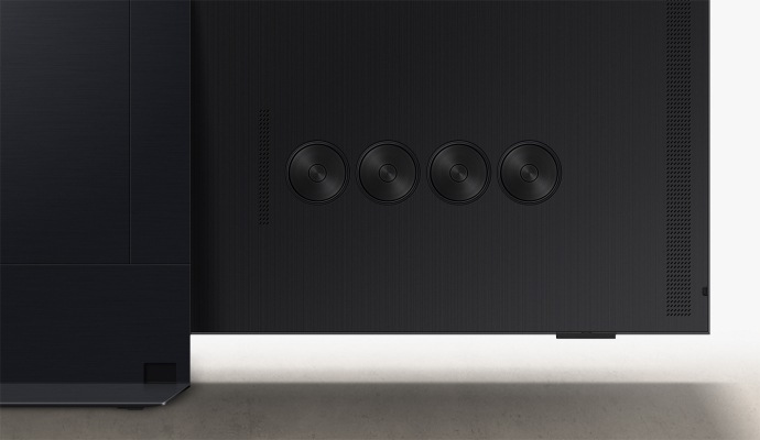 A close-up of four round speakers built into the back of a TV.