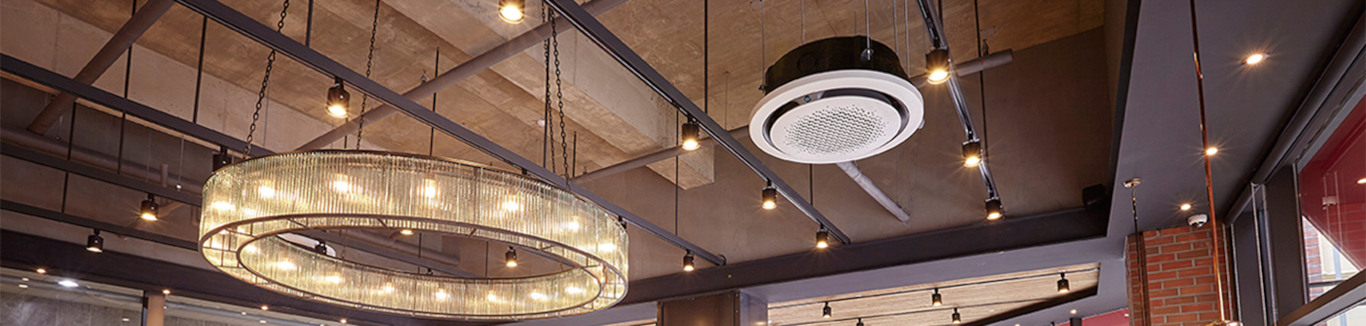 A 360 Cassette indoor unit is installed in a ceiling of a cafe with a Chandelier