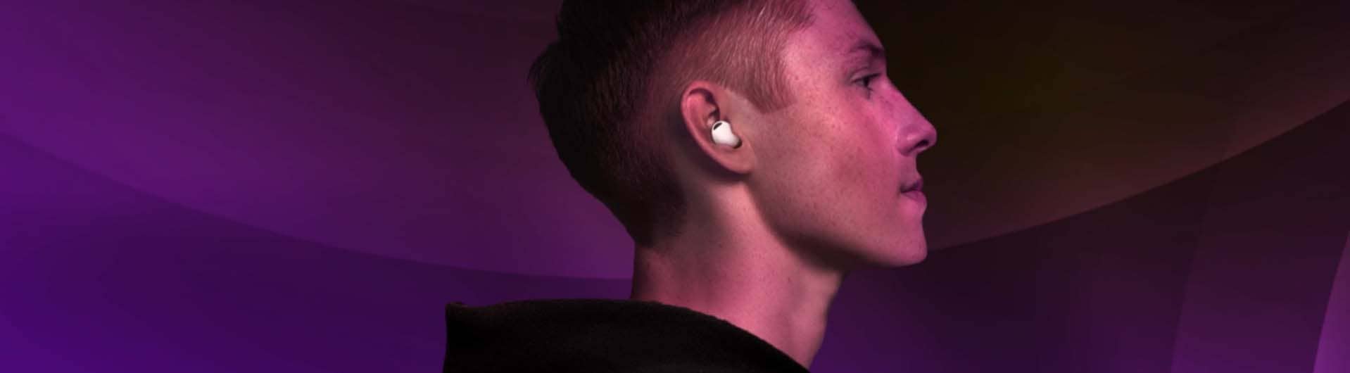 A man showing a Buds2 Pro in his ear