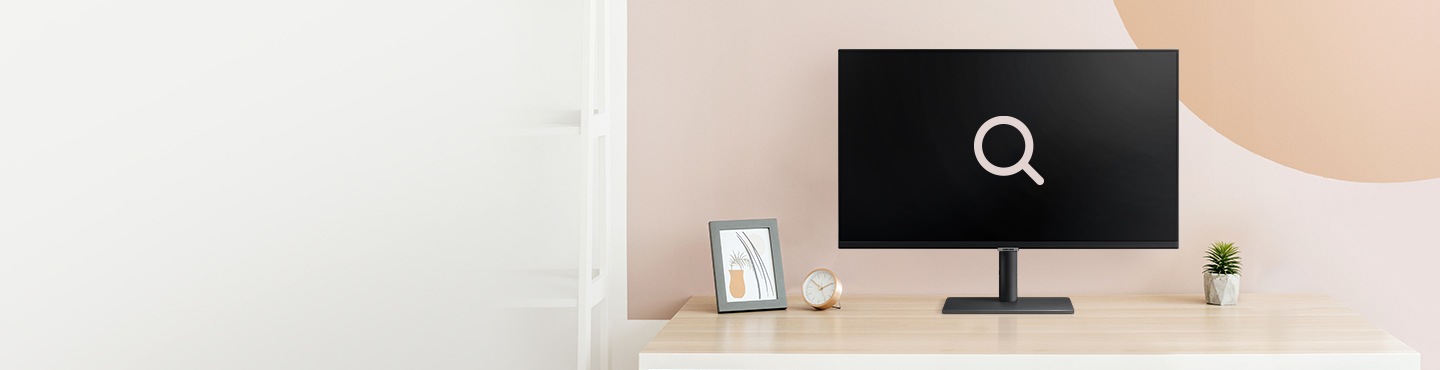 A beige-pink background. A monitor on top of the wooden table with a big search icon.