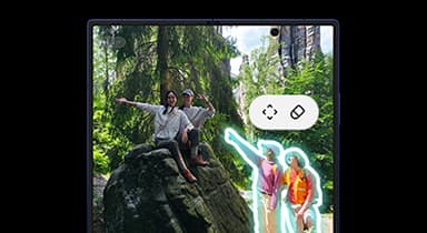 A photo of two people hiking is being edited with Photo Assist on the main display of a Galaxy Z Fold7. Other people in the background have been highlighted for the eraser tool.