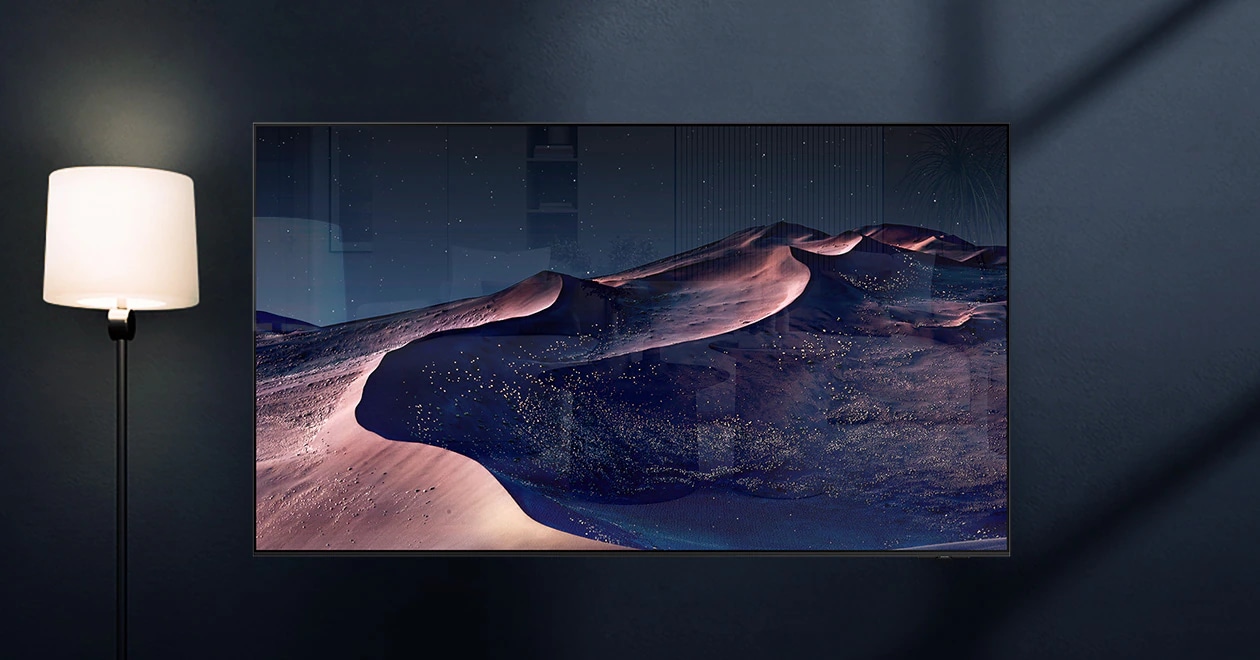 A TV displays a scene of a desert in a starry night. A nearby lamp throws distracting reflections on the screen. With glare-free technology, the screen becomes clear. No discomfort, disability, reflection icons. UL Verified Logo. Glare Free: Reflection Glare UGR < 10, Discomfort Glare < UGR 22, Disability Glare < 34. verifyUL.com®. V166045.