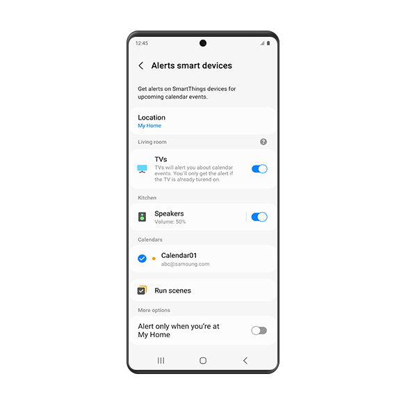 A Galaxy smartphone screen showing the 'Alerts on smart devices' settings page. On the page, it shows that upcoming calendar events can be notified on smart devices in the preset location. The "Location" is set to 'My Home.' Alerts for living room TV and kitchen speakers are enabled. 'Calendar01' is enabled in the Calendars option. Underneath is the "Run scenes" option. At the bottom, under the 'More options', the "Alert only when you're at [My Home]" setting is turned off.
