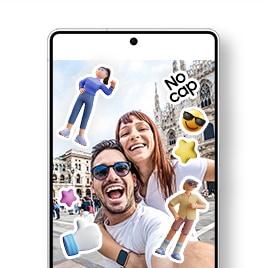 Centered is a Galaxy S25 Ultra displaying a gallery app screen showing a selfie of a cheerful male and female couple at a travel destination. The photo is decorated with cute stickers including a young male character, a confident female character wearing running clothes, a 3D white thumbs-up hand icon with a blue sleeve, pink and yellow 3D star icons, a yellow face emoji with sunglasses, and a "No cap" text sticker.