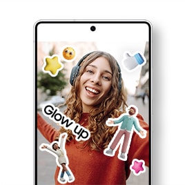 Centered is a Galaxy S25 Ultra displaying a gallery app screen with a selfie of a woman enjoying music and feeling free on the street. The photo is decorated with cute stickers including a stylish female character raises both arms, a male character spreads his arms, pink and yellow 3D star icons, a 3D white thumbs-up hand icon with a blue sleeve, a yellow face emoji with a satisfied expression, and a "Glow up" text sticker.