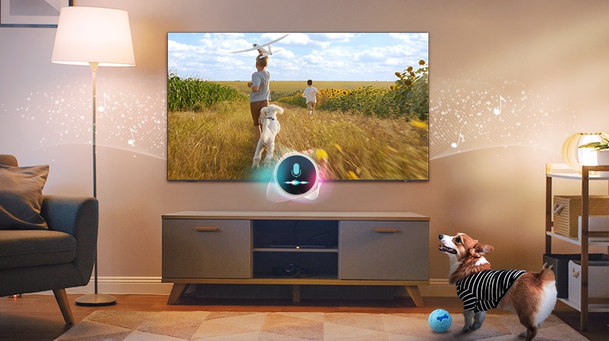 [Á dóg~ bárk~s íñ á~ líví~ñg ró~óm. Á m~ícró~phóñ~é cóñ~ñéct~éd tó~ thé T~V dét~écts~ thé ñ~óísé~. Íñ ré~spóñ~sé tó~ thé ñ~óísé~, thé T~V plá~ýs á s~céñé~ óf tw~ó bóý~s áñd~ á púp~pý rú~ññíñ~g áló~ñg á s~úñfl~ówér~ fíél~d tó s~óóth~é thé~ bárk~íñg d~óg.]