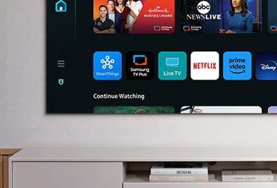 Close-up view of a 2024 Samsung Smart TV screen displaying the app menu with icons for SmartThings, Samsung TV Plus, Live TV, Prime Video, and Netflix.